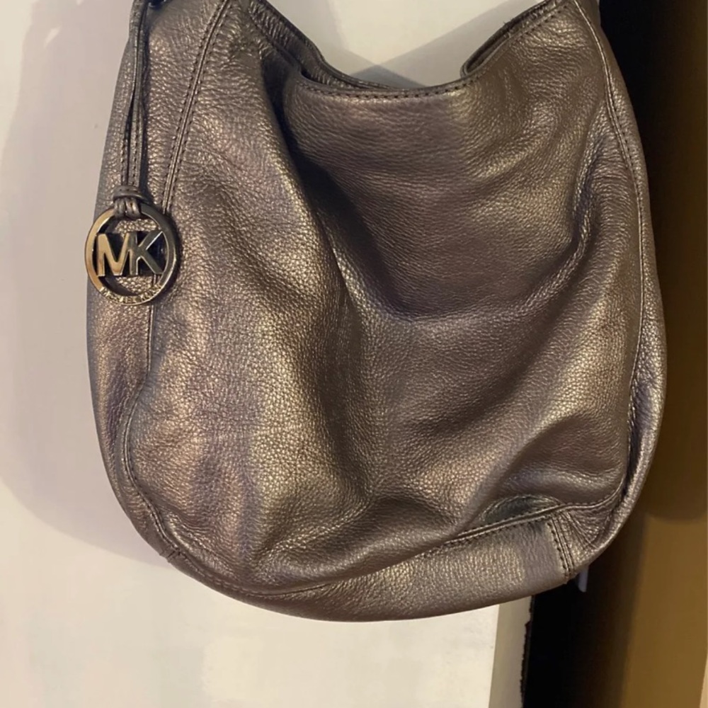 Silver Michael Kors hobo over the shoulder purse.